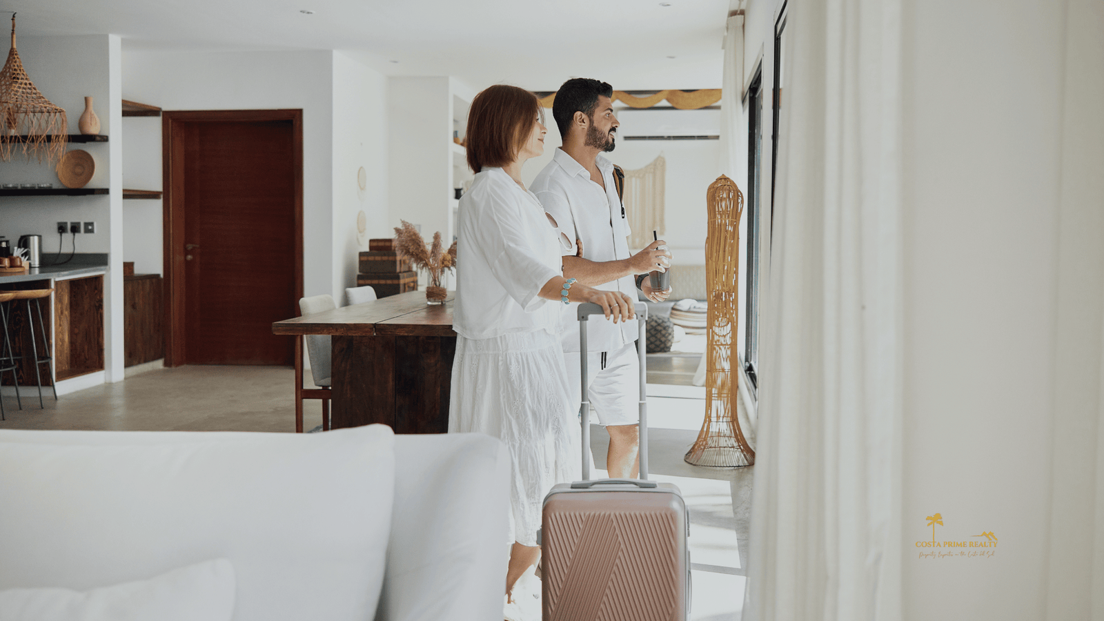 Couple arriving with luggage at a modern Airbnb apartment in Spain, typical tourist rental property