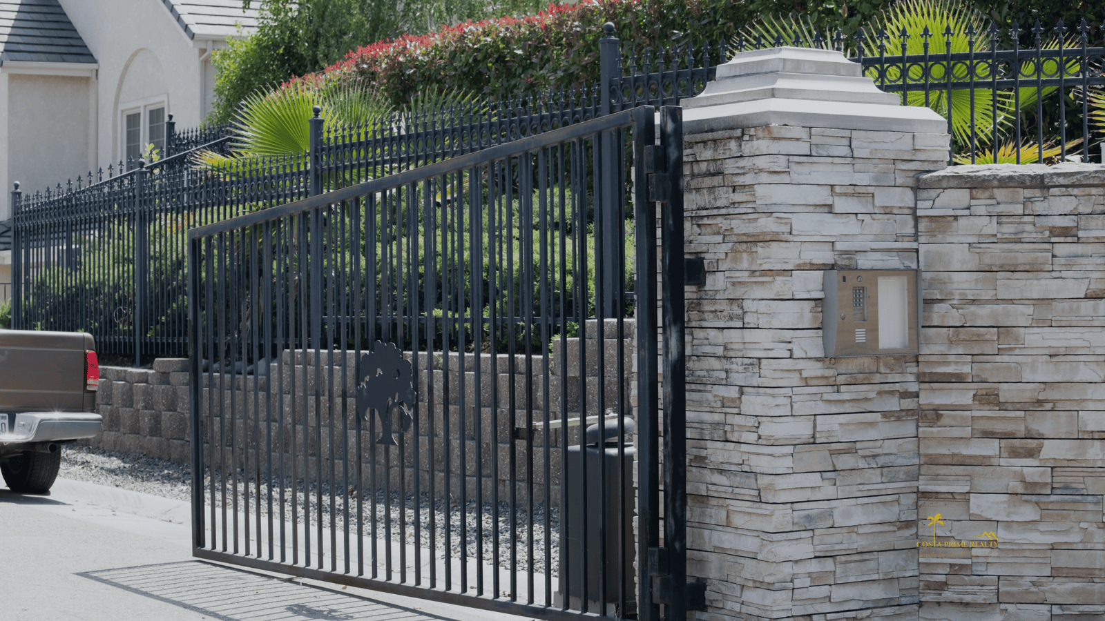 Gated residential community entrance with security gate and intercom system in a private neighborhood on the Costa del Sol