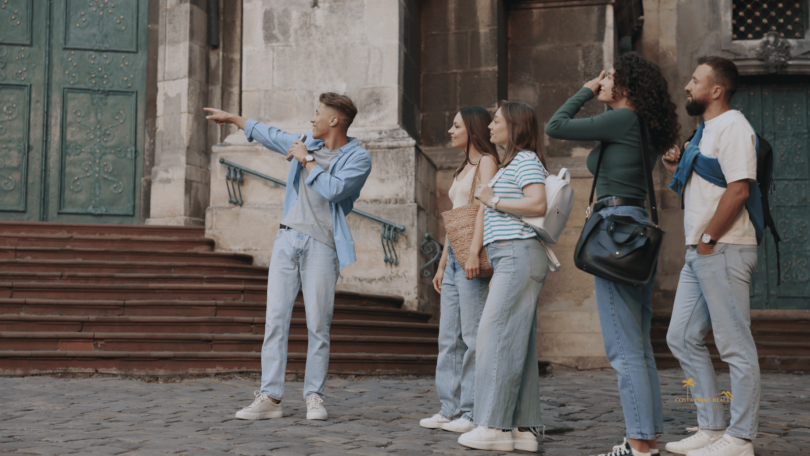 Group of tourists exploring a historic Spanish city while considering moving to Spain.